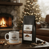 Two Mugs Coffee package and steaming mug on a table with a fireplace and Christmas tree in the background